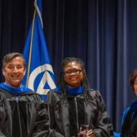 Provost and guests smiling